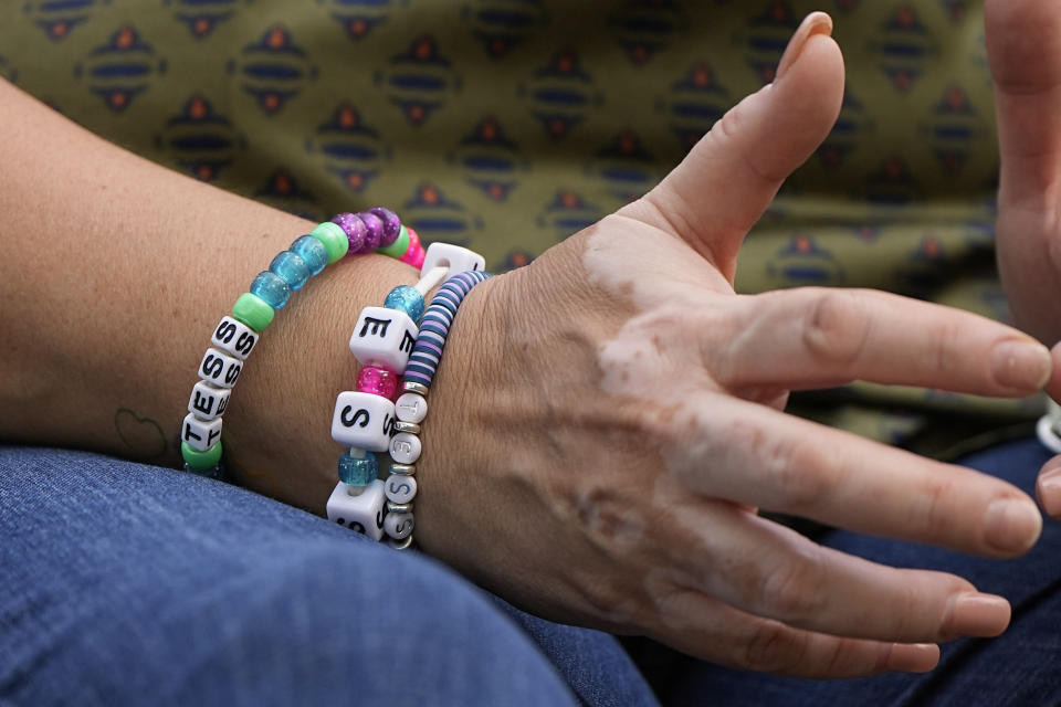 Veronica Mata wears bracelets to honor her daugher, Tess, in Uvalde, Texas, Wednesday, May 3, 2023. For Mata, teaching kindergarten in Uvalde after her daughter was among the 19 students who were fatally shot at Robb Elementary School became a year of grieving for her own child while trying to keep 20 others safe. (AP Photo/Eric Gay)