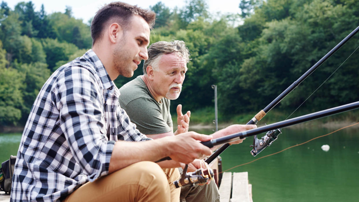 Men talking and fishing together.