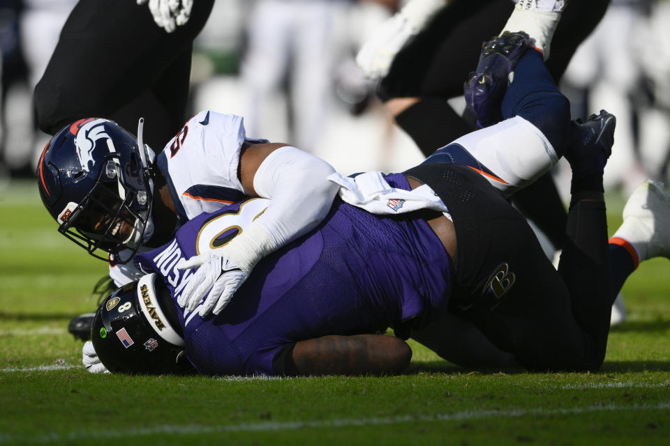 Baltimore Ravens quarterback Lamar Jackson (8) is sacked by Denver Broncos linebacker Jonathon Cooper (53), in the first half of an NFL football game, Sunday, Dec. 4, 2022, in Baltimore. (AP Photo/Nick Wass)