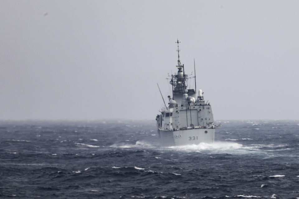 In this photo provided by U.S. Navy, The Royal Canadian Navy Halifax-class frigate HMCS Vancouver (FFH 331) transits the Taiwan Strait with guided-missile destroyer USS Higgins (DDG 76) while conducting a routine transit on Sept. 20, 2022. China toned down its rhetoric on Taiwan on Wednesday, Sept. 21, saying it is inevitable that the self-governing island comes under its control but that it would promote efforts to achieve that peacefully. The comments came one day after the U.S. and Canadian navies sailed through the strait between China and Taiwan. (Mass Communication Specialist 1st Class Donavan K. Patubo/U.S.Navy via AP)