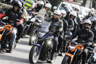 Brazil's President Jair Bolsonaro, center, takes part in a caravan of motorcycle enthusiasts who gathered in a show of support for Bolsonaro, in Sao Paulo, Brazil, Saturday, June 12, 2021. (AP Photo/Marcelo Chello)