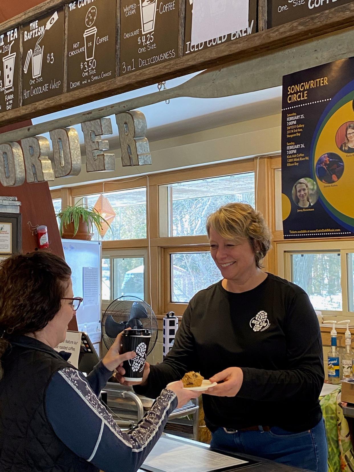 Carol Ash serves a customer at her Kick Ash Door County retail store in Ellison Bay. Ash used what she learned in the Entrepreneurial Training Program at the Door County Economic Development Corp. to help her develop a business plan and buy the building housing the store and kitchen for the business' artisan granola, gluten-free bakery and coffees.