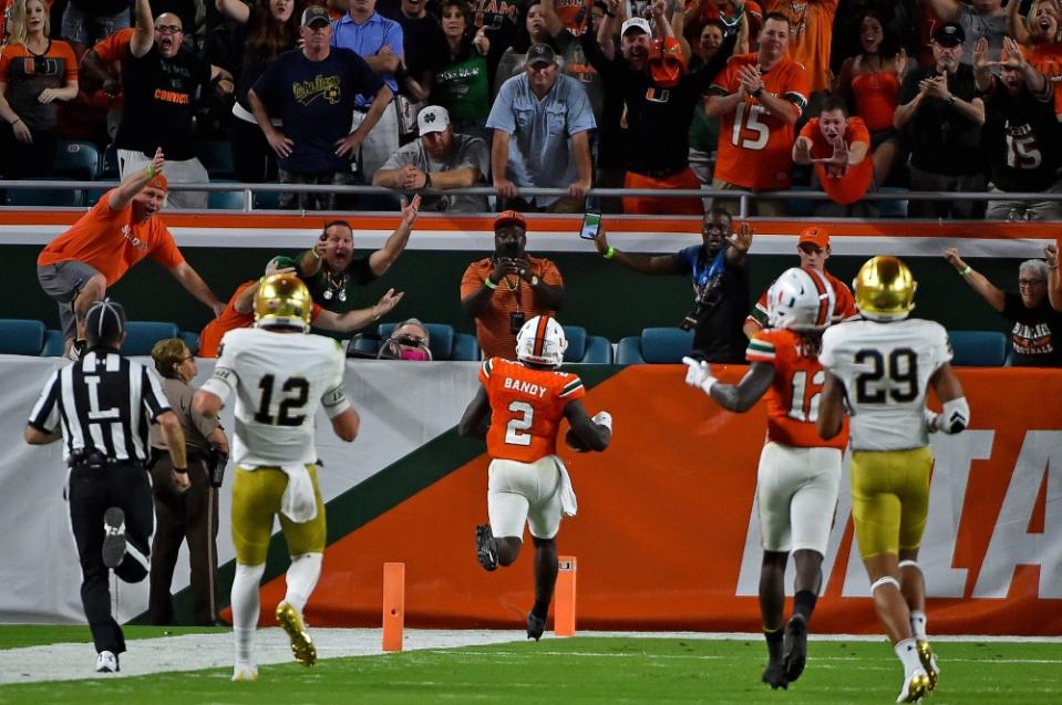 Nov 11, 2017; Miami Gardens, FL, USA; Miami Hurricanes defensive back Trajan Bandy (2) runs into the end zone to score a touchdown after intercepting a pass from Notre Dame Fighting Irish quarterback Ian Book (12) during the first half at Hard Rock Stadium. Mandatory Credit: Jasen Vinlove-USA TODAY Sports