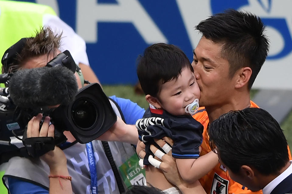 <p>Japan’s goalkeeper Eiji Kawashima (R) greets his son Kensei from the crowd after the final whistle during the Russia 2018 World Cup Group H football match between Japan and Poland at the Volgograd Arena in Volgograd on June 28, 2018. (Photo by NICOLAS ASFOURI / AFP) </p>
