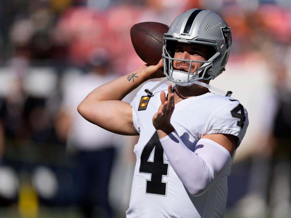 Derek Carr warms up before a game against the Denver Broncos.