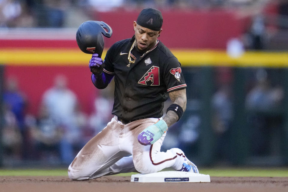 Arizona Diamondbacks' Ketel Marte reacts after getting caught stealing second against the Texas Rangers during the first inning in Game 4 of the baseball World Series Tuesday, Oct. 31, 2023, in Phoenix. (AP Photo/Godofredo A. Vásquez)