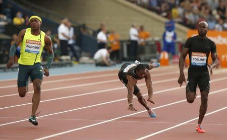 Yohan Blake of Jamaica falls injured in the men's 100m during the IAAF Diamond League athletics meeting at Hampden Park in Glasgow July 11, 2014. REUTERS/Phil Noble