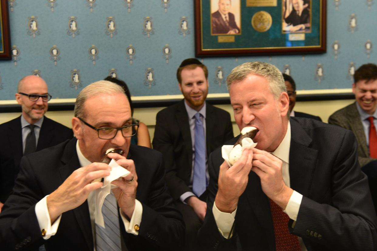 Mayor Bill de Blasio visits Staten Island with numerous city commissioners and officials to sit down with the Borough president Bill Oddo on April 10, 2017. Here, the two break bread over cannolis.