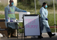 Health officials and members of the military assist during COVID-19 testing, Wednesday, July 8, 2020, at HEB Park in Edinburg, Texas. (Delcia Lopez/The Monitor via AP)
