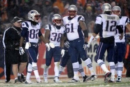 New England Patriots running back Brandon Bolden (38) celebrates his touchdown reception with wide receiver Josh Boyce (82) and offensive tackle Marcus Cannon (61) and quarterback Tom Brady (12) following his touchdown reception in the third quarter against the Denver Broncos at Sports Authority Field at Mile High. Mandatory Credit: Ron Chenoy-USA TODAY Sports