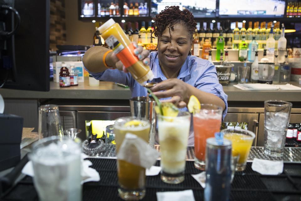 Bartender Jamie Fitzgerald makes drinks during at Main Event in the Christiana Fashion Center in 2018.