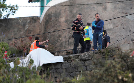 Rescue workers stand at the scene of a bus accident in Canico, in the Portuguese Island of Madeira, April 17, 2019. REUTERS/Duarte Sa