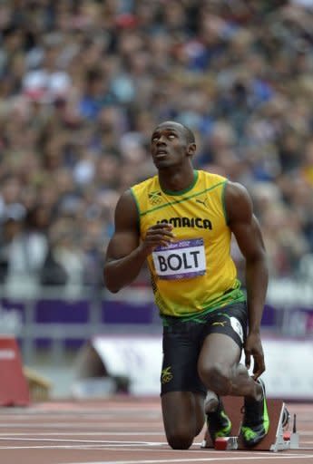 Jamaica's Usain Bolt looks to the heavens before the men's 200m heats at the athletics event during the London 2012 Olympic Games on August 7, 2012 in London