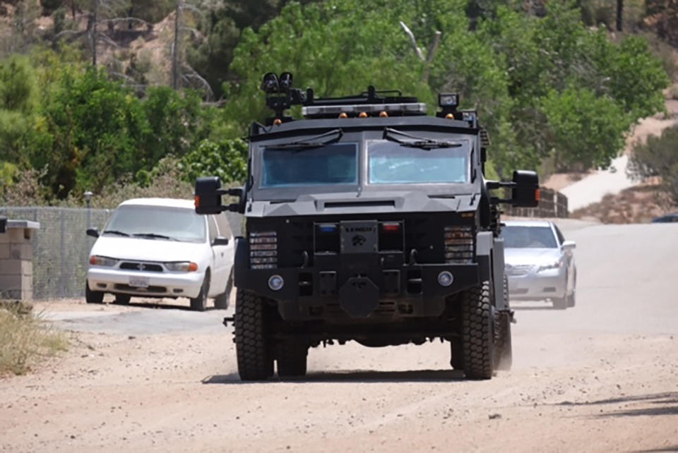 A gunman opened fire at a Los Angeles County fire station in Agua Dulce today, striking at least two people -- one possibly fatally -- before fleeing and apparently setting fire to a home in nearby Acton on Fire and smoke rise from a home in Acton, Calif. on Tuesday, June 1, 2021. Authorities say there's been a shooting at a Los Angeles County Fire Department station. Fire Department Supervisor Leslie Lua said paramedics responded to reports of gunshots at Fire Station 81, about 45 miles (72 kilometers) north of Los Angeles. The home on fire is about 10 miles (16 kilometers) east of the station, and there's a heavy police presence, but it's unclear if it's connected to the shooting and authorities didn't immediately have more information. (David Crane/The Orange County Register via AP)