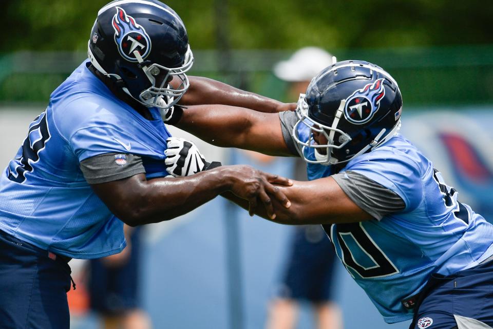 Titans defensive tackles Woodrow Hamilton IV (78) and Bruce Hector (90) work on pass rush drills during practice at Saint Thomas Sports Park Thursday, May 27, 2021 in Nashville, Tenn.