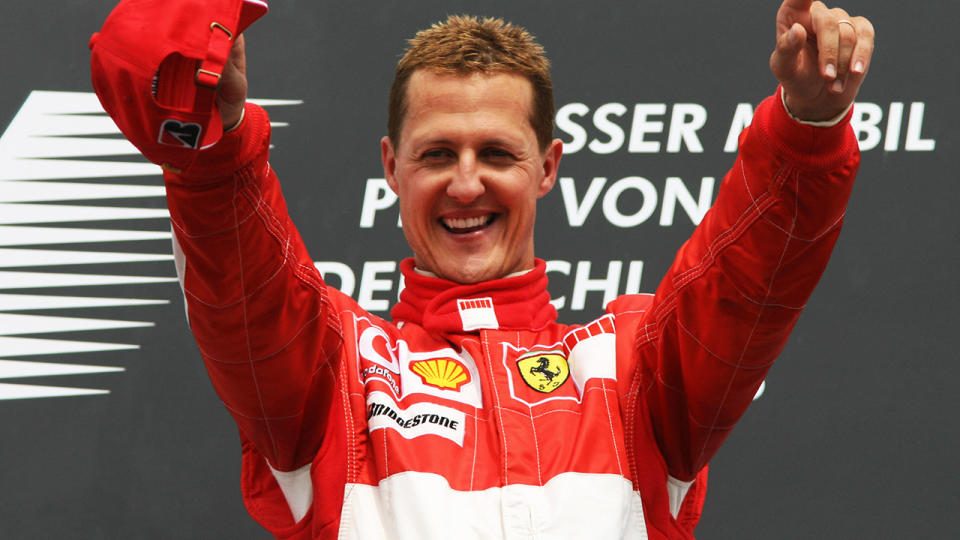 Michael Schumacher celebrates on the podium of the Hockenheim racetrack after the German Grand Prix, 30 July 2006, in Hockenheim. AFP PHOTO PATRIK STOLLARZ (Photo credit should read PATRIK STOLLARZ/AFP/Getty Images)