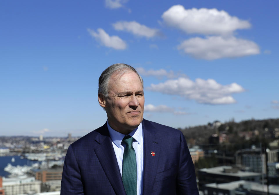 In this March 1, 2019 photo, Washington Gov. Jay Inslee stands on an outdoor patio as he takes part in media interviews in Seattle after announcing earlier in the day that he will seek the 2020 Democratic presidential nomination. Inslee, who made fighting climate change the central theme of his presidential campaign, announced Wednesday night, Aug. 21, 2019, that he is ending his bid for the 2020 Democratic nomination. Inslee announced his decision on MSNBC, saying it's become clear that he won't win. (AP Photo/Ted S. Warren)