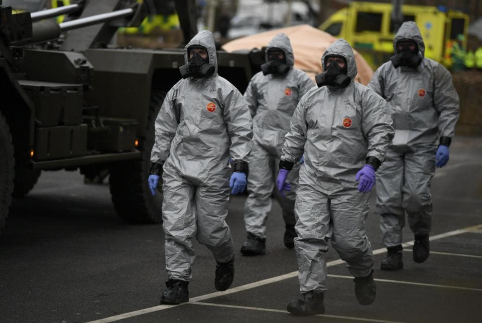 Investigation: Military personnel in protective clothing in Salisbury as the PM calls a meeting of the National Security Council (EPA)