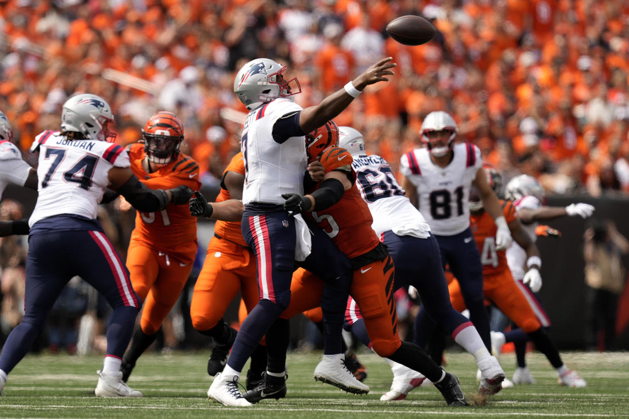 New England Patriots quarterback Jacoby Brissett (7) is hit by Cincinnati Bengals linebacker Logan Wilson (55) as he throws a pass during the second half of an NFL football game, Sunday, Sept. 8, 2024, in Cincinnati. (AP Photo/Carolyn Kaster)