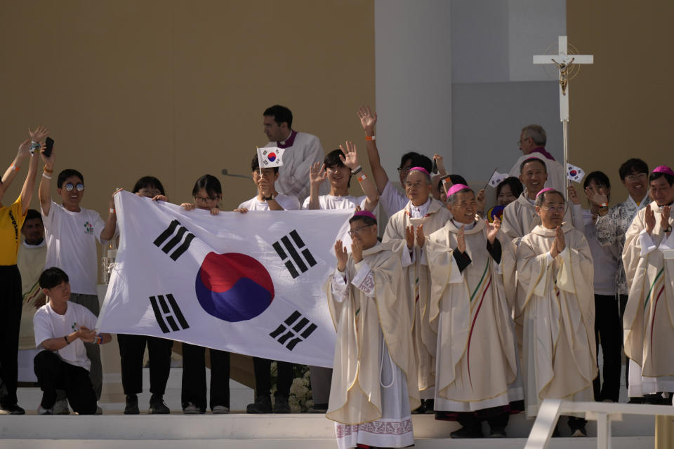 Young pilgrims from South Korea celebrate with their national flag and with Pope Francis after he announced that the next World Youth Day will be in Seoul, South Korea, in 2027, following a mass at Parque Tejo in Lisbon, Sunday, Aug. 6, 2023. An estimated 1.5 million young people filled the parque on Saturday for Pope Francis' World Youth Day vigil, braving scorching heat to secure a spot for the evening prayer and to camp out overnight for his final farewell Mass on Sunday morning. (AP Photo/Francisco Seco)