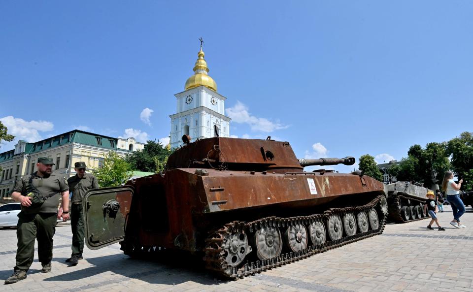 Ukrainian servicemen examine new items displayed at the open-air exhibition of destroyed Russian armoured vehicles in Kyiv (AFP via Getty Images)
