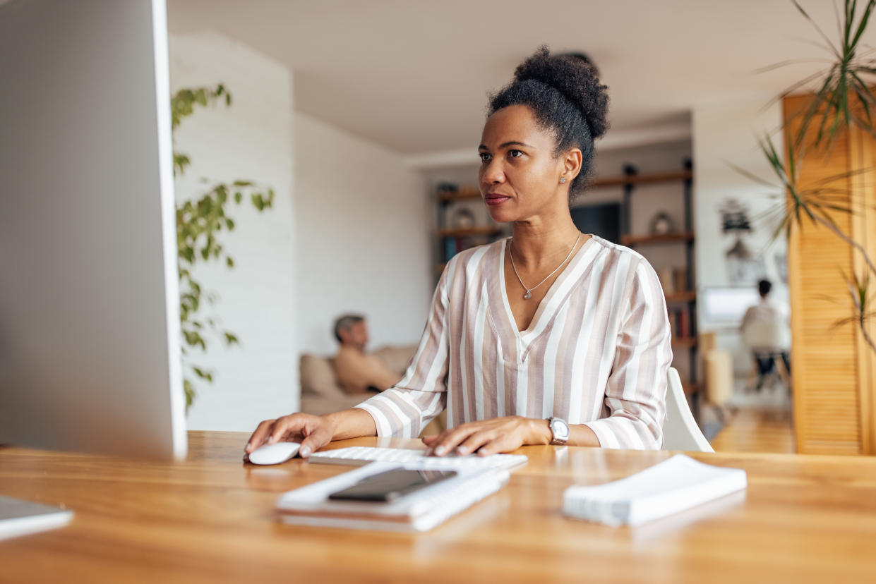 Serious adult woman, focusing on her work, while thinking what to do.