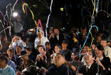 Fans of the Japanese writer Haruki Murakami celebrate after they heard that Japanese-born Kazuo Ishiguro won the Nobel Prize for Literature while they gather in a shrine with the hope of celebrating Murakami's winning in the prize in Tokyo, Japan, October 5, 2017. REUTERS/Kim Kyung-Hoon