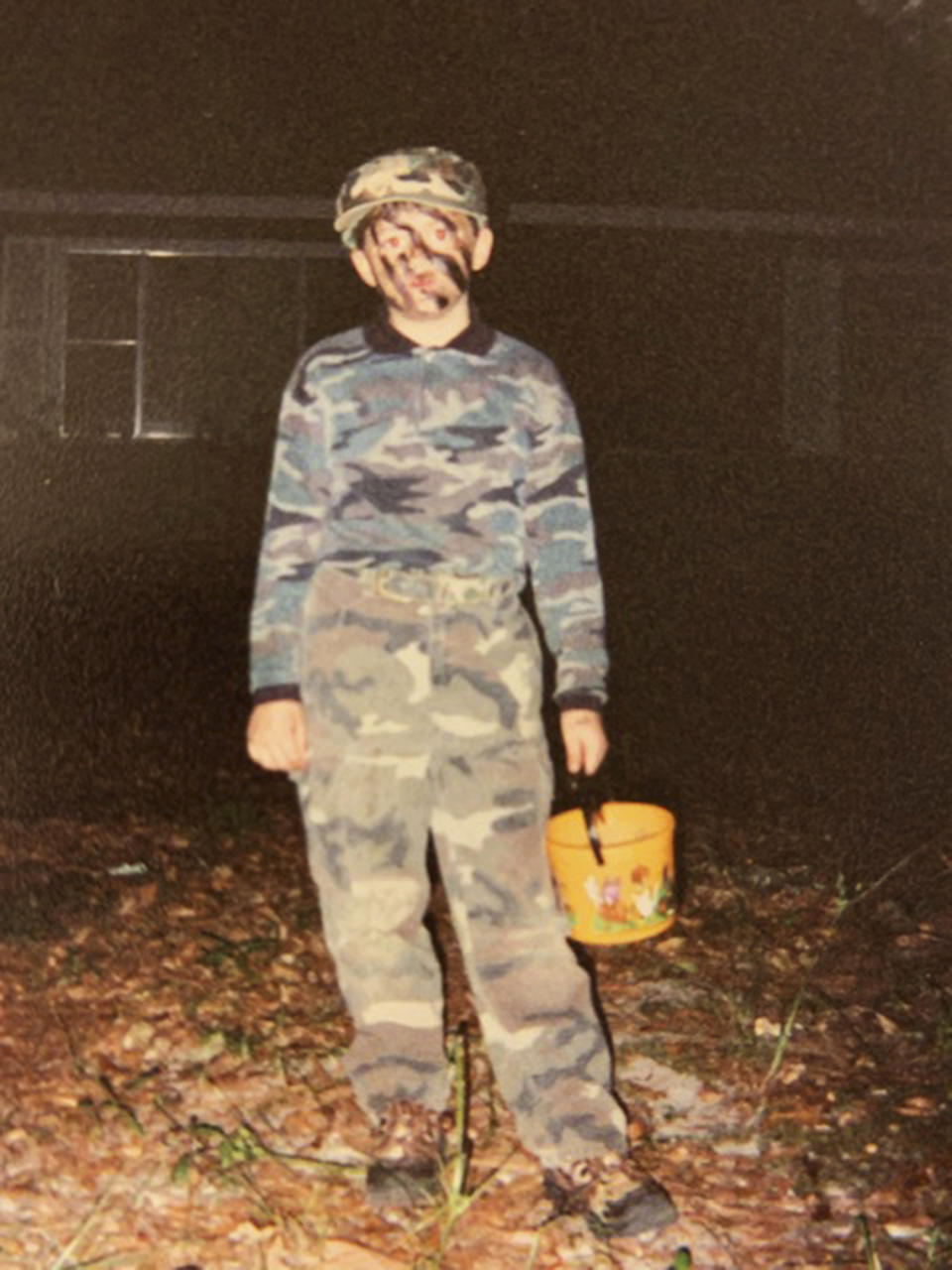 This October 2001 photo provided by Paula Kovach shows her nephew, James Johnston as a boy dressed in camouflage for Halloween in Nacogdoches, Texas. As a toddler, Johnston liked to play in the triple-degree Texas summers in cargo shorts and heavy-duty camouflage, digging foxholes in his front yard. His mother, Meghan Billiot, recalls he once asked to have a toy driver’s license created for him with the designation “Special Forces” and code name Silver Falcon. (Paula Kovach via AP)