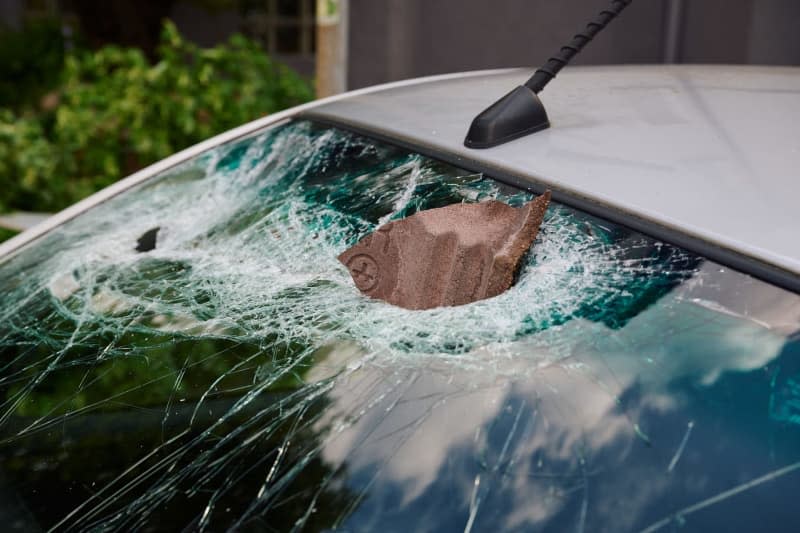 A piece of roof tile blown off during a strong wind, likely a tornado, struck the windshield of a parked car. Clean-up work continued on Thursday. Bernd Thissen/dpa
