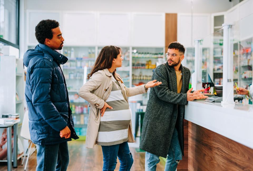 pregnant person confronting a person the person in front of them in line