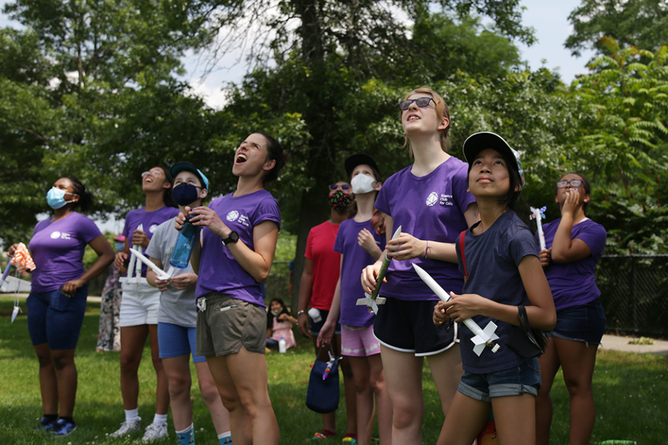 Students and Science Club for Girls’ program manager watch as a rocket ascends above Danehy Park in Somerville, Massachusetts on July 17, 2021 (Marianna McMurdock)