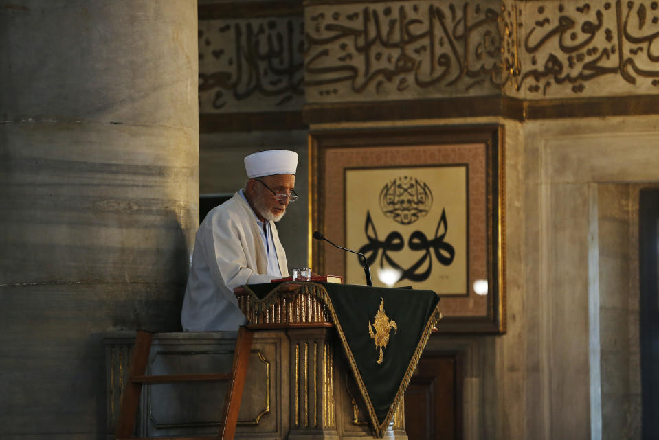 An imam reads a sermon before prayers at a mosque in Istanbul, Wednesday, Aug. 15, 2018. The Turkish lira has nosedived in value in the past week over concerns about Turkey's President Recep Tayyip Erdogan's economic policies and after the United States slapped sanctions on Turkey angered by the continued detention of an American pastor. (AP Photo/Lefteris Pitarakis)