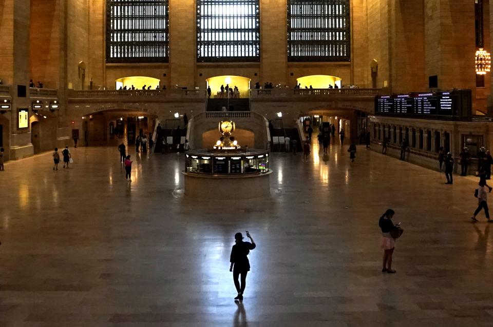 A woman stands with her cellphone in Grand Central Terminal, the  historic world-famous landmark and transportation hub in Midtown Manhattan July 21, 2020 in New York. - The station is the southern terminus of the Metro-North Railroad's Harlem, Hudson and New Haven Lines and ridership has been down during the height of the coronavirus pandemic. (Photo by TIMOTHY A. CLARY / AFP) (Photo by TIMOTHY A. CLARY/AFP via Getty Images)