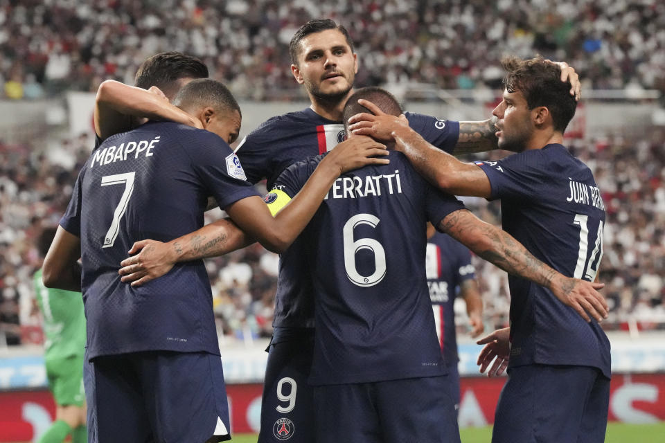 Paris Saint-Germain's Kylian Mbappe, left, is congratulated by teammates after scoring his team's second goal during a friendly soccer match between Paris Saint-Germain and Urawa Reds at Saitama Stadium in Saitama, north of Tokyo, Saturday, July 23, 2022. (AP Photo/Eugene Hoshiko)