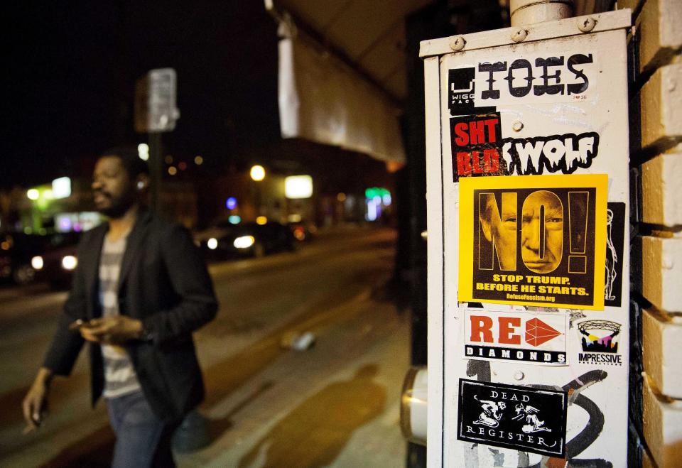 An anti-Donald Trump sticker is posted to an electrical box along the main business district in East Atlanta, Ga., in Dekalb County, Wednesday, Jan. 11, 2017. The county is a Democratic stronghold east of downtown Atlanta. Hillary Clinton won four out of five DeKalb votes, capitalizing on a heavy African-American population, a burgeoning Hispanic community and a bevy of white liberals, many of them from elsewhere. (AP Photo/David Goldman)