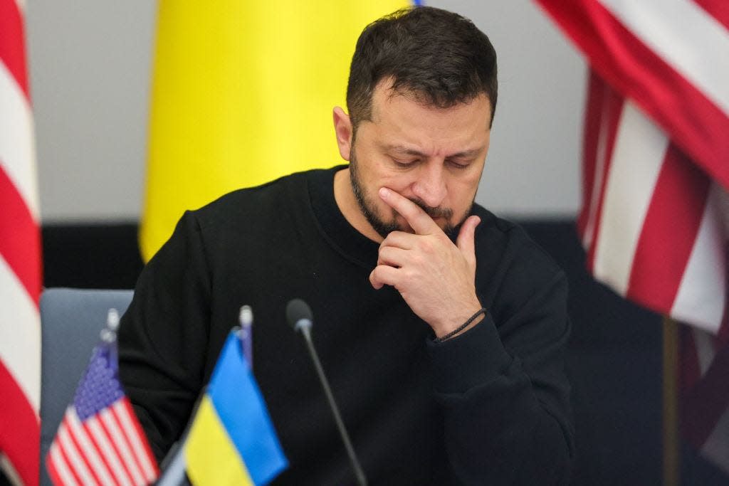 Ukraine President Volodymyr Zelensky put his hand to his chin and thinks