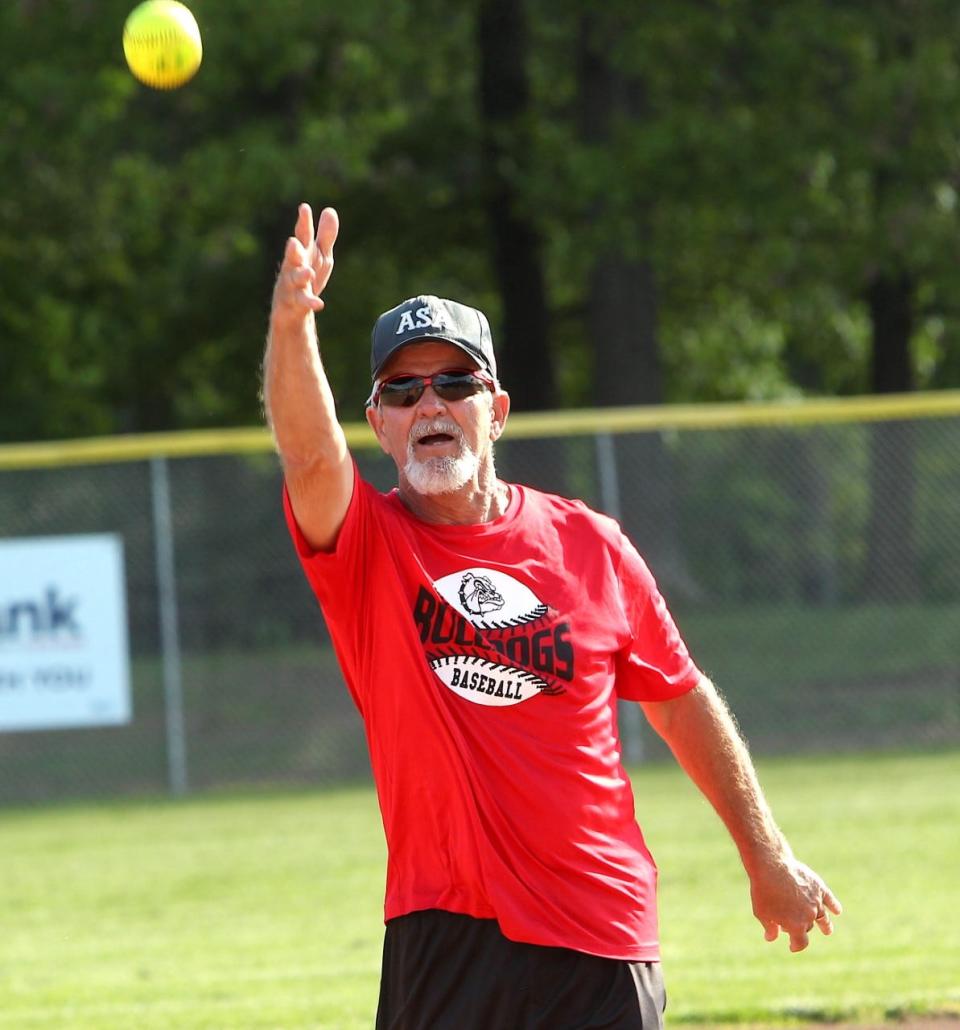 Ralph "Froggy" Poole throws out the ceremonial first pitch to start the 2022 slow-pitch softball season at Murray Park Monday night. Poole was honored after retiring from 39 years as an umpire.