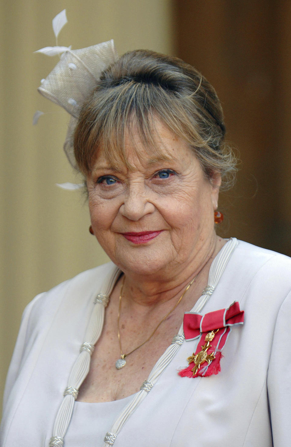 In this file photo dated Oct. 18, 2007, Sylvia Syms looks on at Buckingham after collecting her OBE from Queen Elizabeth II, in London. Actress Sylvia Syms, who starred in classic British films including “Ice Cold in Alex” and “Victim,” has died, her family said Friday, Jan. 27, 2023. She was 89. (Fiona Hanson/PA via AP)