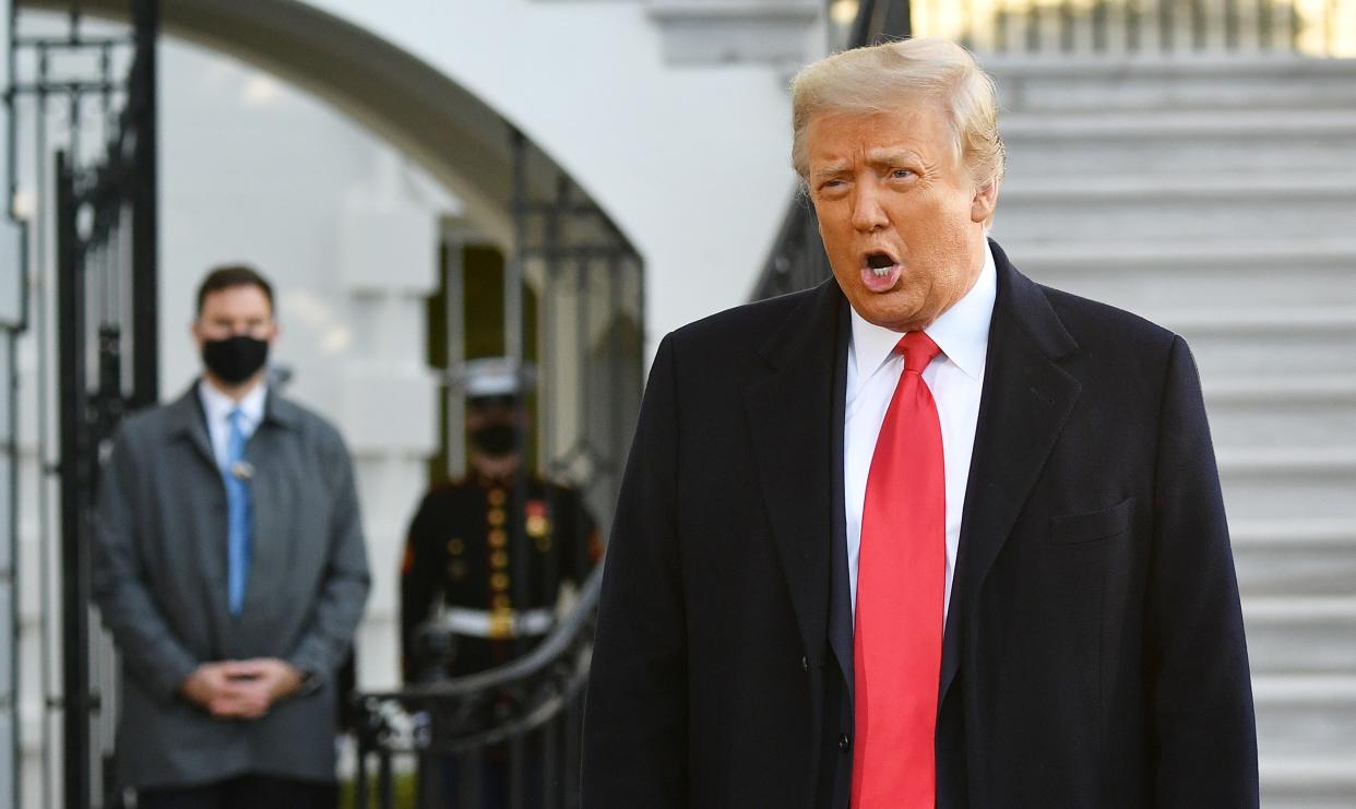 US President Donald Trump speaks to the media before boarding Marine One as he departs the White House in Washington, DC, on January 20, 2021. (Photo by MANDEL NGAN / AFP) (Photo by MANDEL NGAN/AFP via Getty Images)