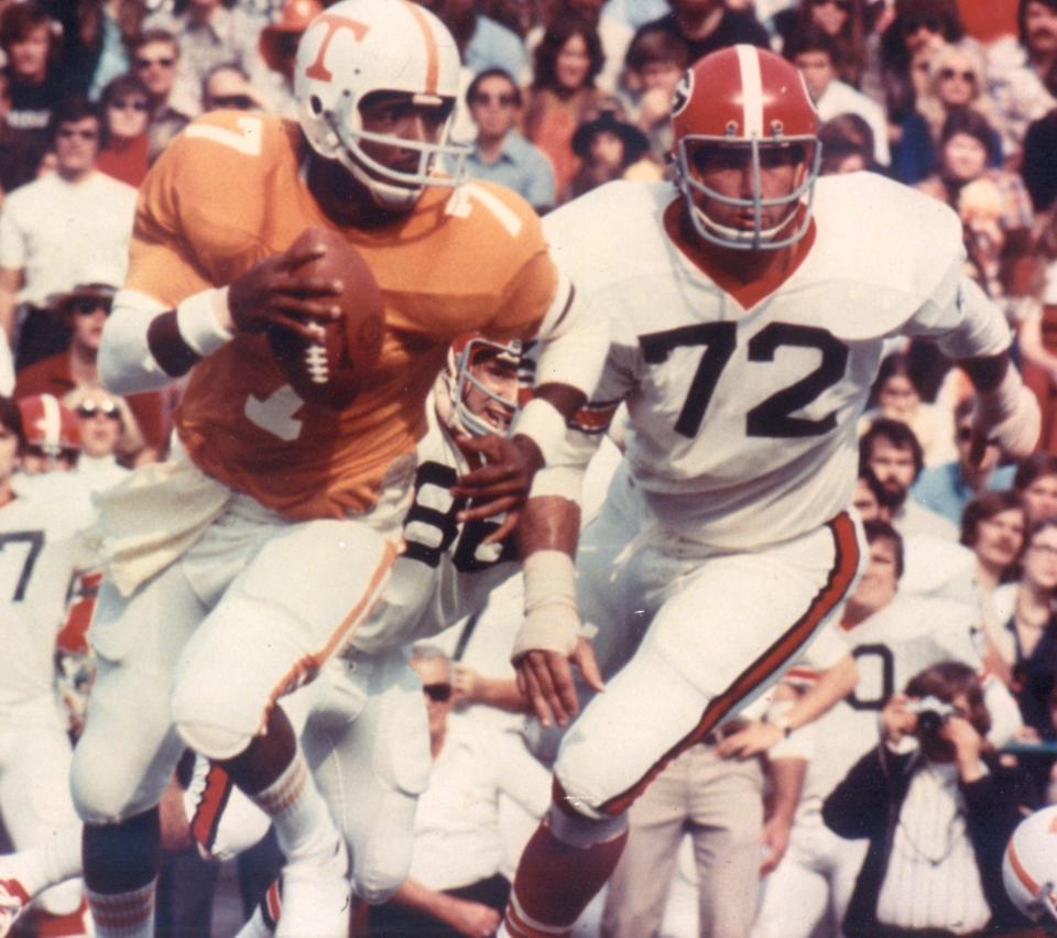 Tennessee quarterback Condredge Holloway scrambles against Georgia. He led the Vols to three straight bowls from 1972-74.