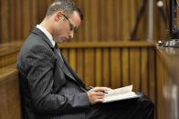 Olympic and Paralympic track star Oscar Pistorius sits in the dock during court proceedings at the North Gauteng High Court in Pretoria March 18, 2014. Pistorius is on trial for murdering his girlfriend Reeva Steenkamp at his suburban Pretoria home on Valentine's Day last year. REUTERS/Marco Longari/Pool (SOUTH AFRICA - Tags: SPORT CRIME LAW ATHLETICS)