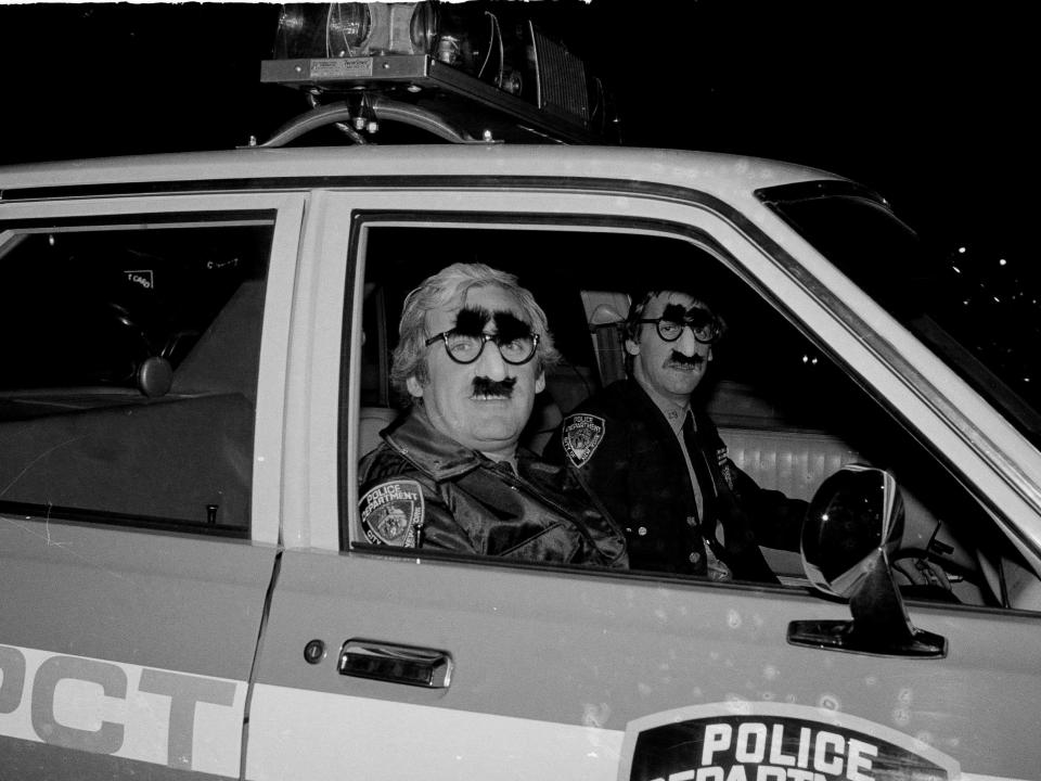 Police officers wearing Halloween costumes in 1980.