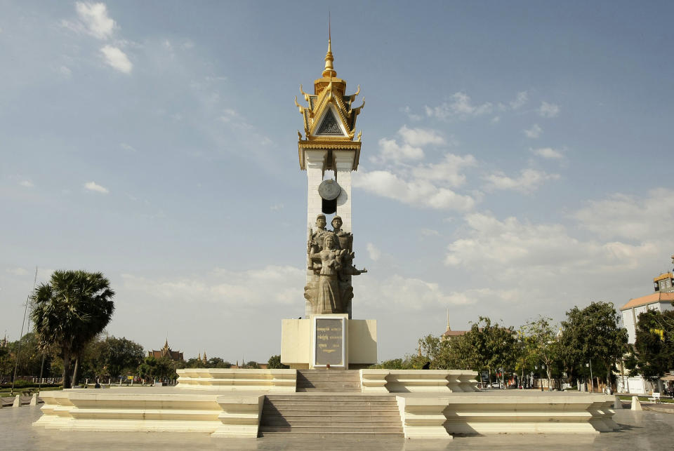 In this photo taken, Feb. 25, 2013, the Cambodian Vietnamese Friendship Monument is seen at a public park near the Royal Palace, in Phnom Penh, Cambodia. Glowing or not, it was constructed in 1958 to commemorate independence from the French that had been achieved five years prior. The concrete soldiers at the base of the Cambodian Vietnamese Friendship Monument, on the other hand, pay tribute to an alliance formed between the two countries in the aftermath of the 1979 fall of the Khmer Rouge. (AP Photo/Heng Sinith)