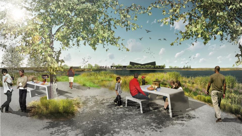 A rendering shows people sitting at picnic tables by a lake