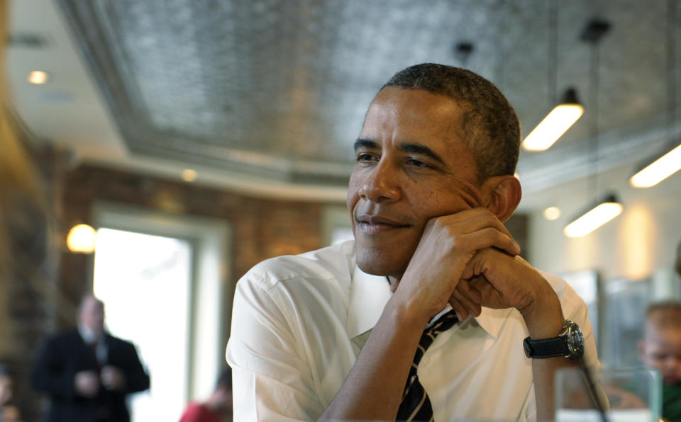 President Barack Obama listens as he has lunch with five young people at The Coupe restaurant in the Columbia Heights section of Washington, Friday, Jan. 10, 2014. The five are spearheading creative outreach efforts to connect with and help enroll young consumers through the Marketplaces or are interested in getting more involved with these efforts. (AP Photo/Susan Walsh)