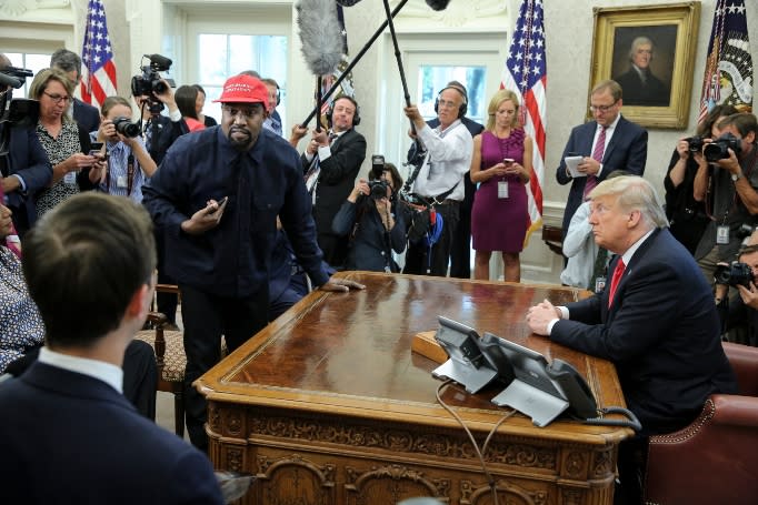 Rapper Kanye West stands up as he speaks during a meeting with U.S. President Donald Trump in the Oval office of the White House on October 11, 2018 in Washington, DC.