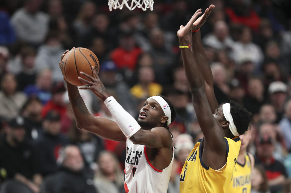 Portland Trail Blazers forward Jerami Grant, left, drives to the basket as Indiana Pacers forward Pascal Siakam defends during the first half of an NBA basketball game Friday, Jan. 19, 2024, in Portland, Ore. (AP Photo/Amanda Loman)