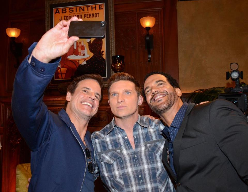 Christian Le Blanc, Steve Burton, and Kristoff St. John pose for a selfie at "The Young And The Restless" 41st Anniversary, on Tuesday, March 25, 2014, in Los Angeles. (Photo by Tonya Wise/Invision/AP)
