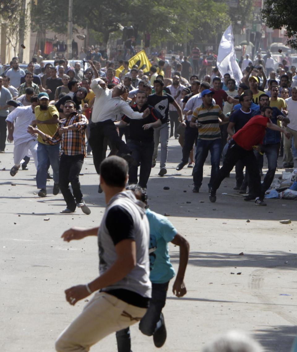 Supporters of deposed President Mohamed Mursi and the Muslim Brotherhood clash with anti-Mursi protesters during a march in Shubra street in Cairo October 4, 2013. Clashes broke out in Cairo and several other Egyptian cities on Friday during protest marches staged by supporters of deposed President Mohamed Mursi of the Muslim Brotherhood, security sources and state media said. REUTERS/ Mohamed Abd El Ghany (EGYPT - Tags: POLITICS CIVIL UNREST)