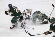 Minnesota Wild defenseman Matt Dumba (24) and Chicago Blackhawks left wing Boris Katchouk (14) go after the puck during the third period of an NHL hockey game Saturday, March 25, 2023, in St. Paul, Minn. Minnesota won 3-1. (AP Photo/Stacy Bengs)